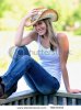 stock-photo-beautiful-young-country-and-western-girl-in-white-tank-top-blue-jeans-and-a-western-.jpg